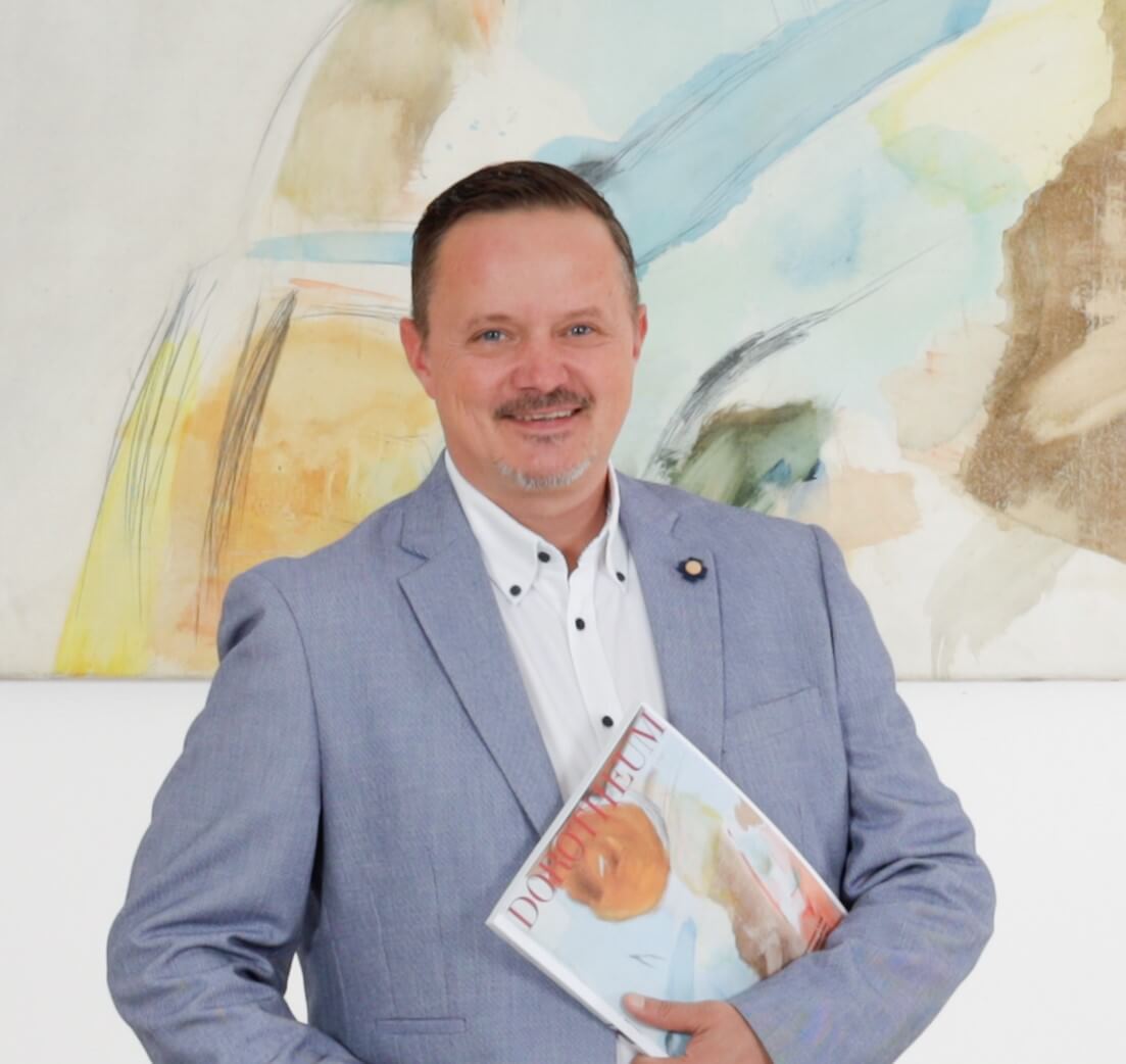 filialleiter-in-anzug-vor-einem-gemaelde-in-der-filiale